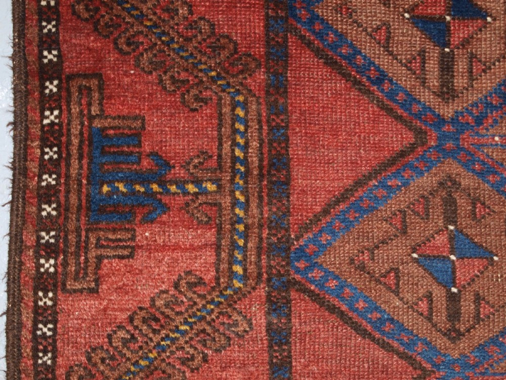 ANTIQUE AFGHAN RUG OF BALUCH LATTICE DESIGN, WARM COLOURS, CIRCA 1900/20. View VII