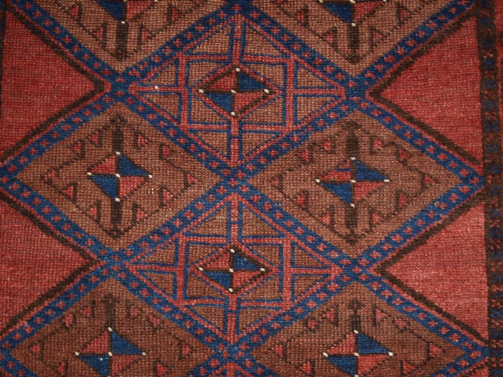 ANTIQUE AFGHAN RUG OF BALUCH LATTICE DESIGN, WARM COLOURS, CIRCA 1900/20. View VIII