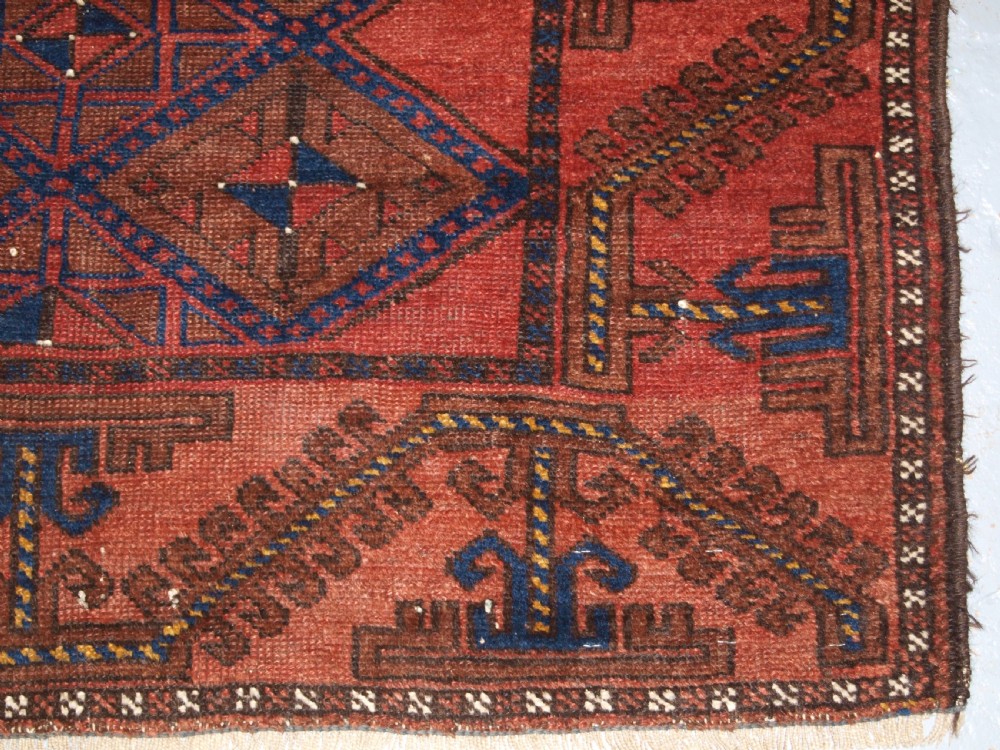 ANTIQUE AFGHAN RUG OF BALUCH LATTICE DESIGN, WARM COLOURS, CIRCA 1900/20. View IX