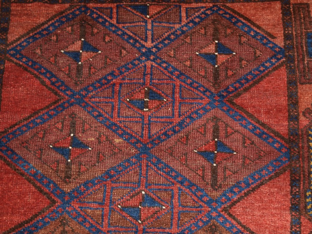 ANTIQUE AFGHAN RUG OF BALUCH LATTICE DESIGN, WARM COLOURS, CIRCA 1900/20. View X
