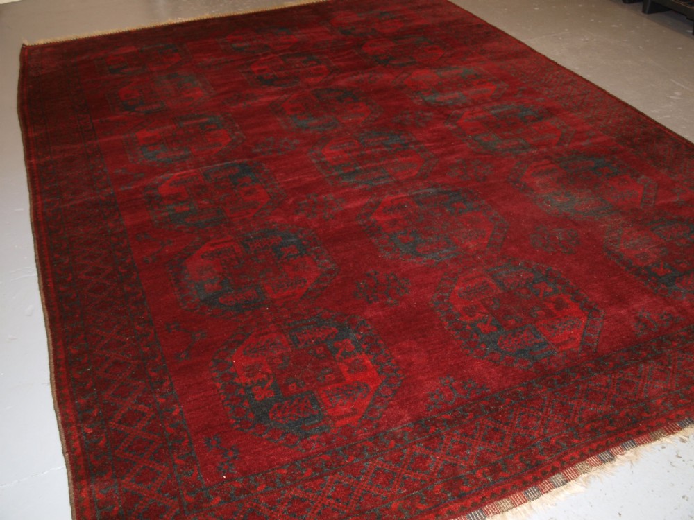 ANTIQUE AFGHAN ERSARI TURKMEN CARPET, DEEP PLUM RED COLOUR, CIRCA 1900.