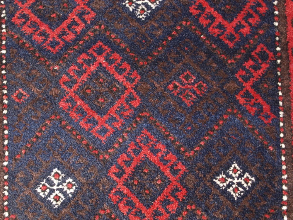 OLD AFGHAN BALUCH RUG WITH REPEAT DESIGN AND CLASSIC BALUCH BORDER, CIRCA 1920. View VII
