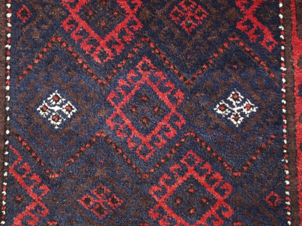 OLD AFGHAN BALUCH RUG WITH REPEAT DESIGN AND CLASSIC BALUCH BORDER, CIRCA 1920. View VIII