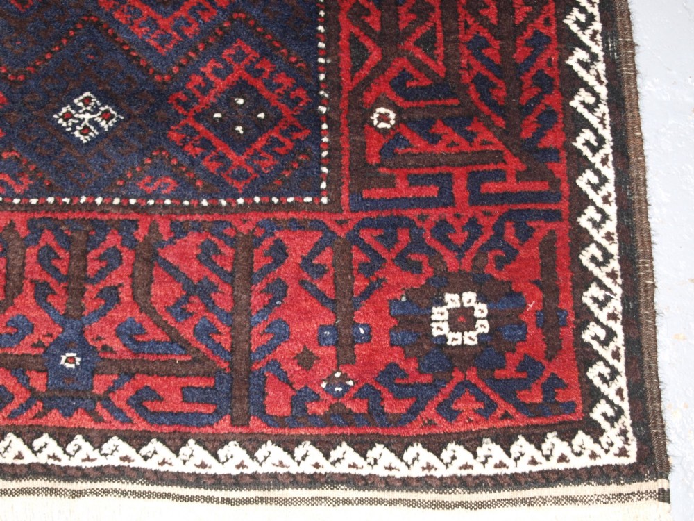 OLD AFGHAN BALUCH RUG WITH REPEAT DESIGN AND CLASSIC BALUCH BORDER, CIRCA 1920. View X