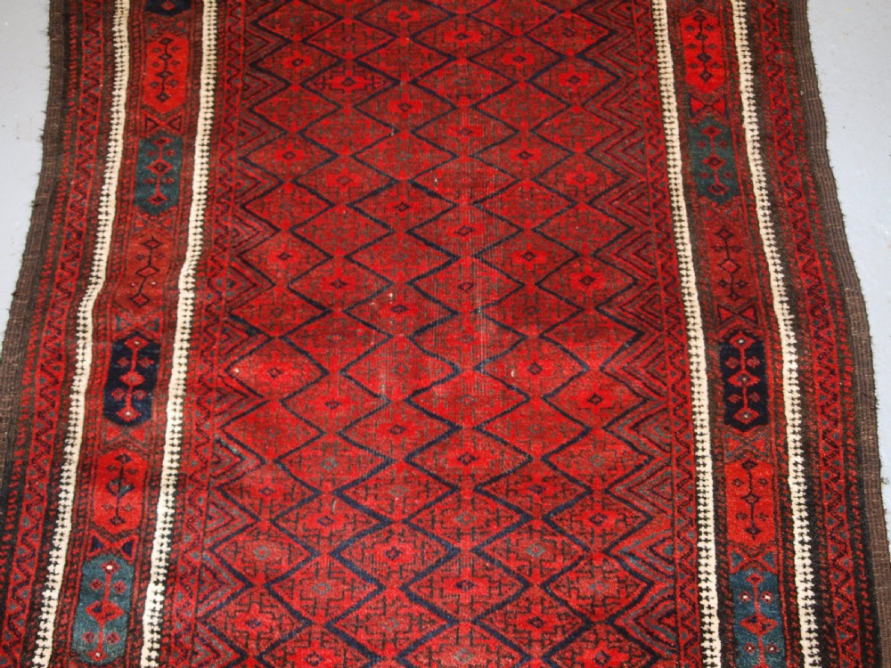 ANTIQUE BALUCH RUG WITH FINE DIAMOND LATTICE DESIGN, INTERESTING BORDER, CIRCA 1900. View VI