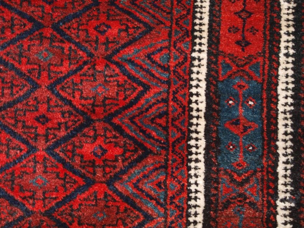 ANTIQUE BALUCH RUG WITH FINE DIAMOND LATTICE DESIGN, INTERESTING BORDER, CIRCA 1900. View IX
