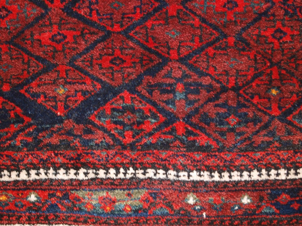 ANTIQUE BALUCH RUG WITH FINE DIAMOND LATTICE DESIGN, INTERESTING BORDER, CIRCA 1900. View X