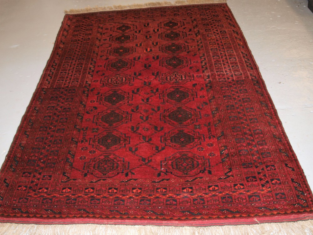 OLD AFGHAN VILLAGE RUG WITH TURKMEN CHUVAL GUL DESIGN, PLUM RED COLOUR, CIRCA 1920. View II