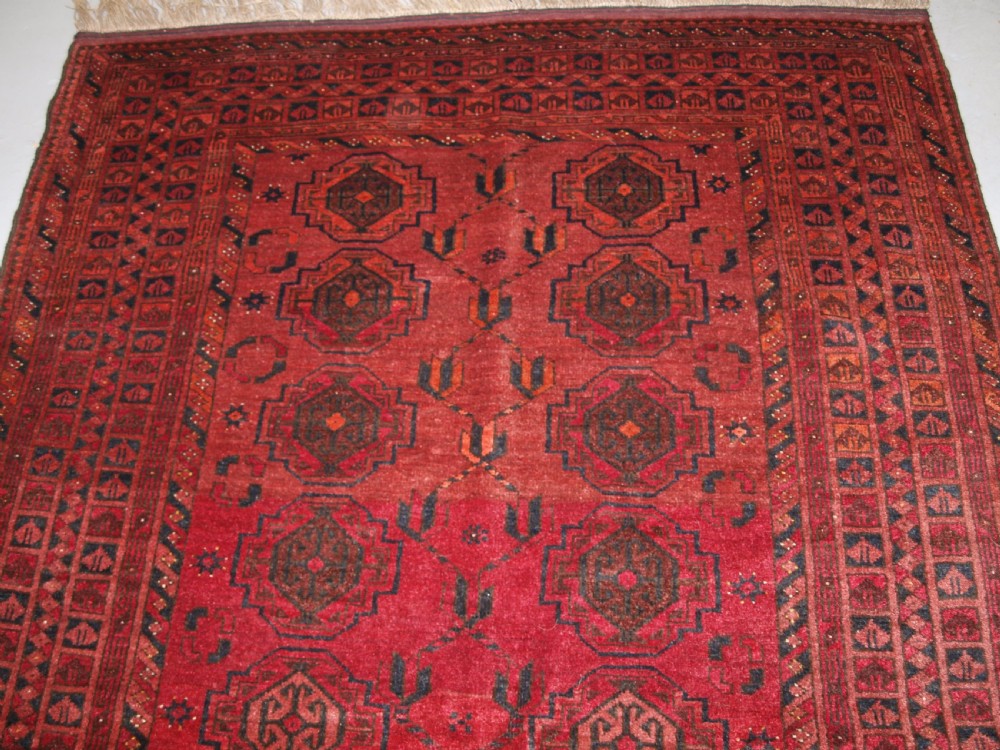 OLD AFGHAN VILLAGE RUG WITH TURKMEN CHUVAL GUL DESIGN, PLUM RED COLOUR, CIRCA 1920. View V