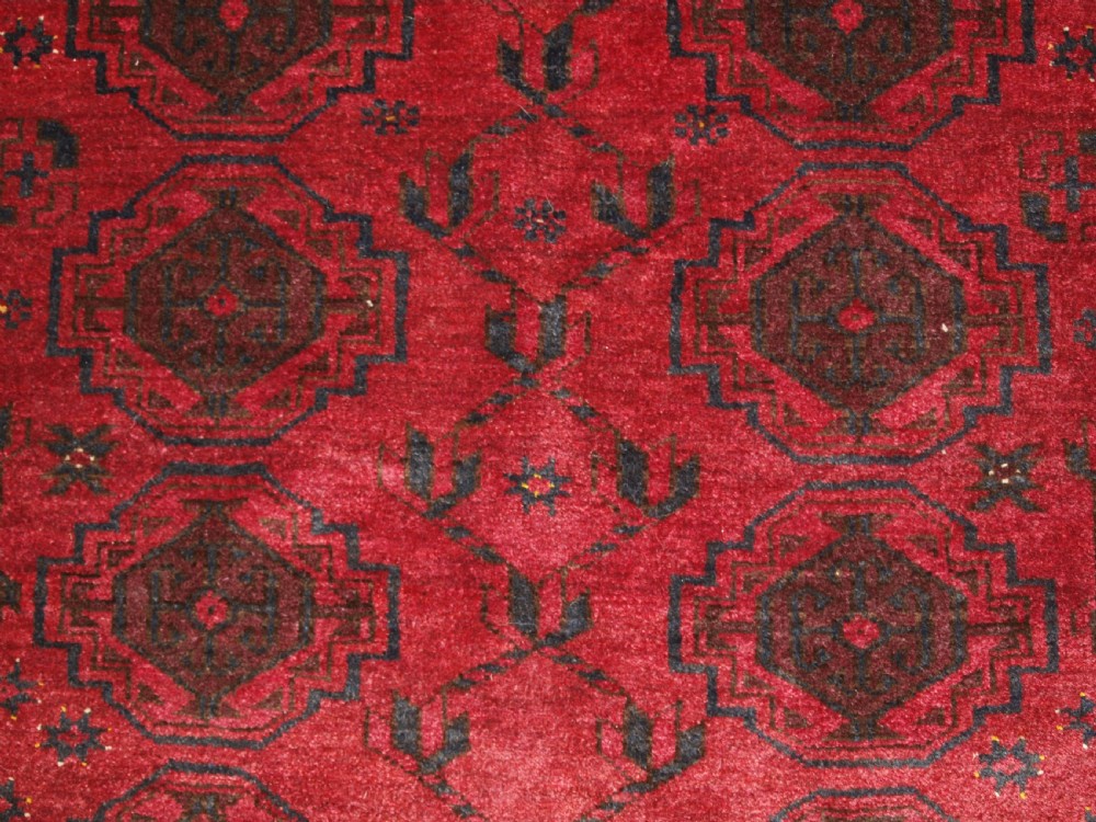 OLD AFGHAN VILLAGE RUG WITH TURKMEN CHUVAL GUL DESIGN, PLUM RED COLOUR, CIRCA 1920. View X