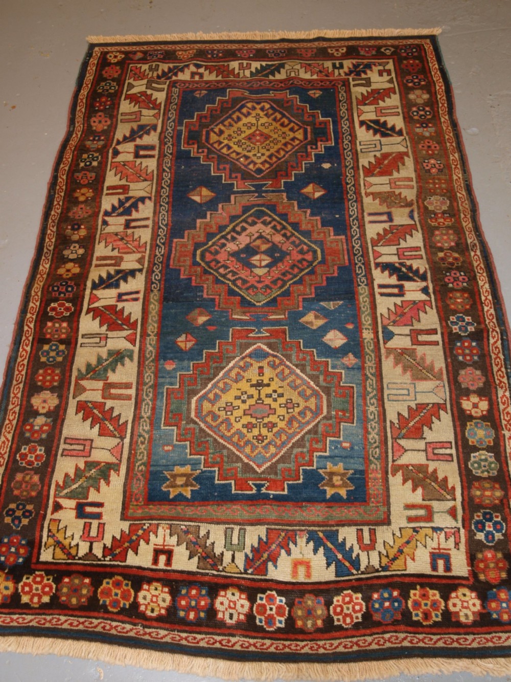 ANTIQUE CAUCASIAN KAZAK THREE MEDALLION RUG WITH SUPERB SOFT COLOURS, CIRCA 1900.