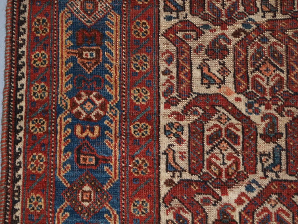 ANTIQUE RUG BY THE KHAMSEH TRIBE, ALL OVER BOTEH DESIGN ON AN IVORY FIELD, CIRCA 1900. View IV