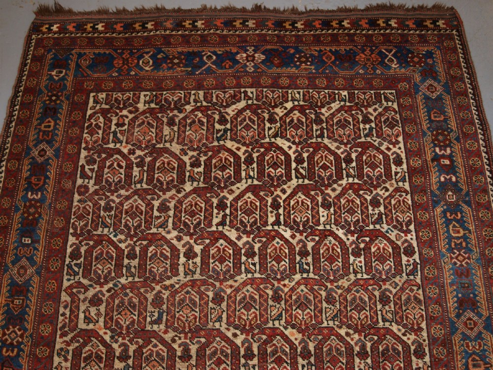 ANTIQUE RUG BY THE KHAMSEH TRIBE, ALL OVER BOTEH DESIGN ON AN IVORY FIELD, CIRCA 1900. View V