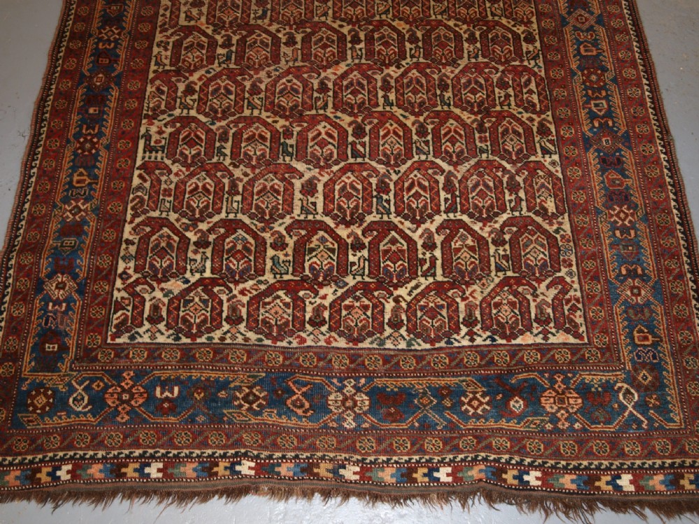 ANTIQUE RUG BY THE KHAMSEH TRIBE, ALL OVER BOTEH DESIGN ON AN IVORY FIELD, CIRCA 1900. View VII
