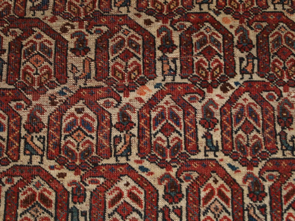 ANTIQUE RUG BY THE KHAMSEH TRIBE, ALL OVER BOTEH DESIGN ON AN IVORY FIELD, CIRCA 1900. View IX
