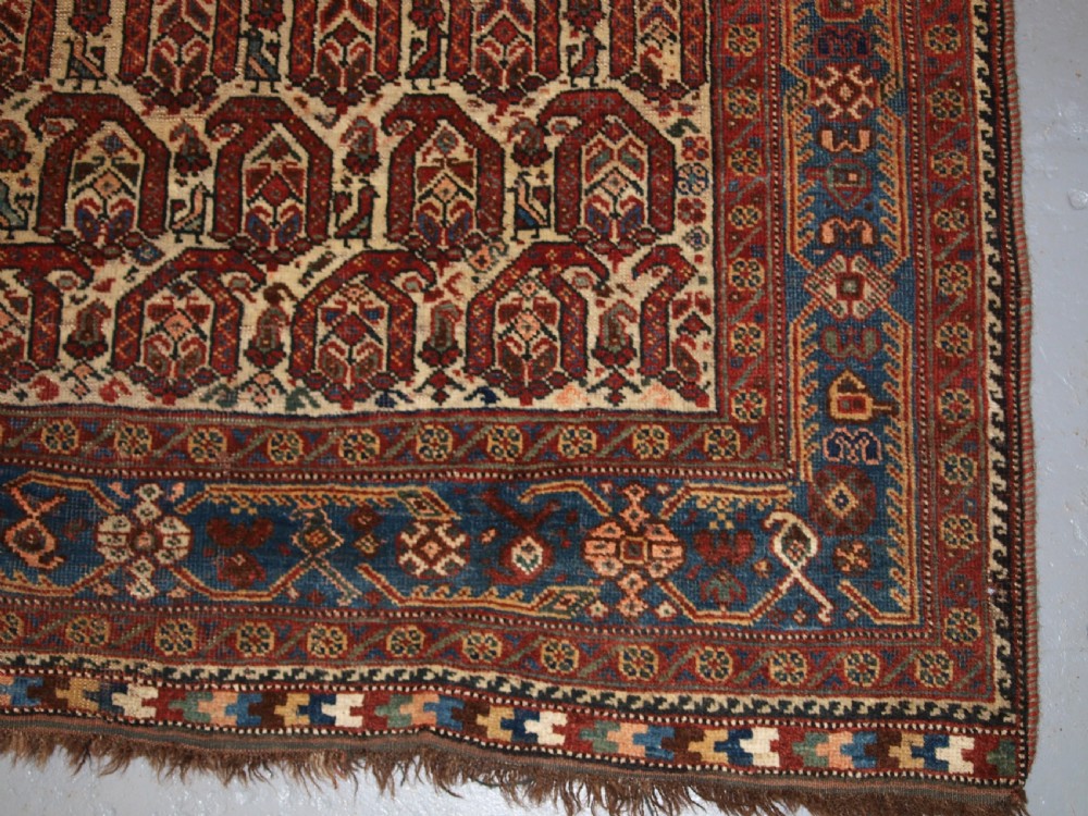 ANTIQUE RUG BY THE KHAMSEH TRIBE, ALL OVER BOTEH DESIGN ON AN IVORY FIELD, CIRCA 1900. View X