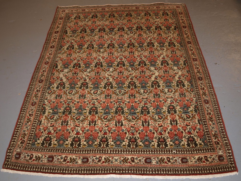 OLD PERSIAN QUM RUG, VERY SOFT COLOURS AND FINE WEAVE, CIRCA 1920.