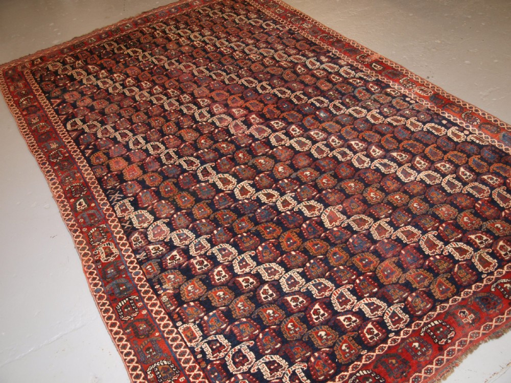 ANTIQUE PERSIAN RUG BY THE KHAMSEH TRIBE WITH ALL OVER BOTEH DESIGN, LATE 19TH CENTURY.
