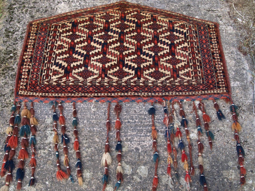 ANTIQUE YOMUT TURKMEN ASMALYK, FULL PILE WITH TASSELS, CIRCA 1900.