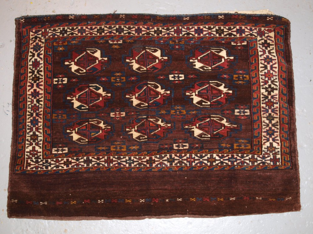 ANTIQUE YOMUT TURKMEN 9 GUL CHUVAL WITH PLAIN WEAVE BACK, LATE 19TH CENTURY.
