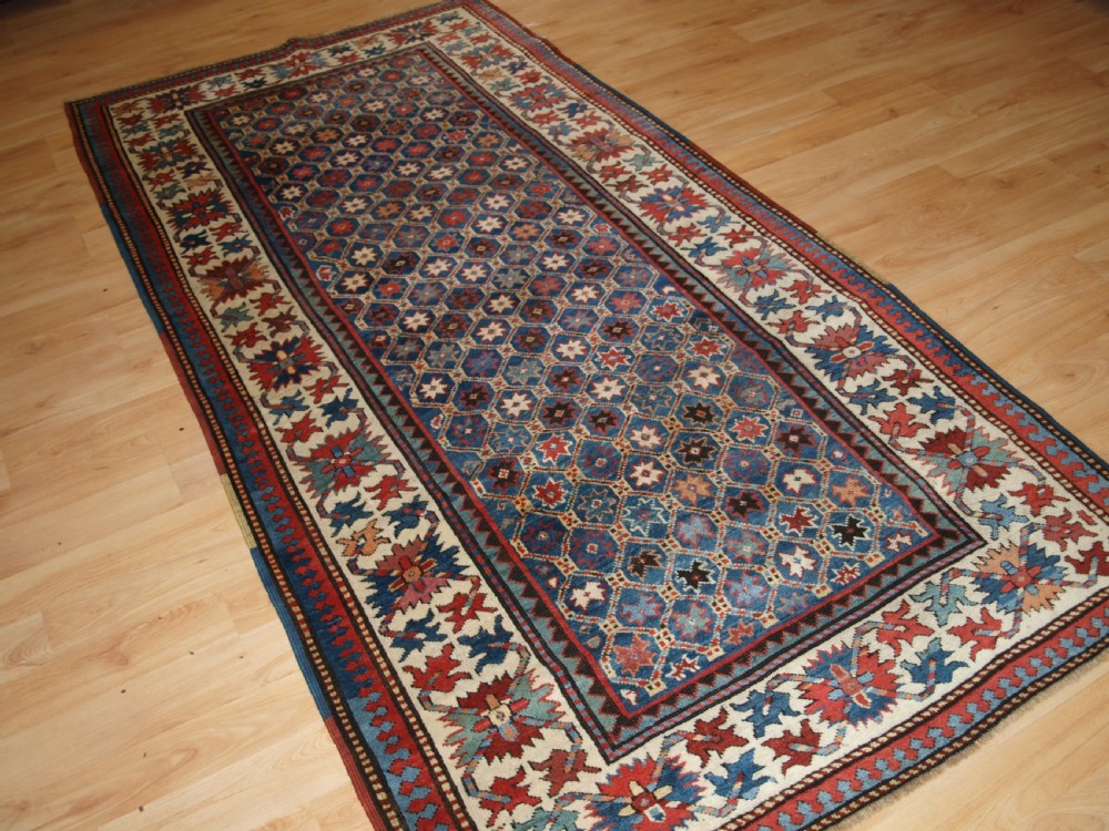 ANTIQUE CAUCASIAN GENDJE KAZAK RUG, LATTICE AND STAR DESIGN, CIRCA 1880. View II