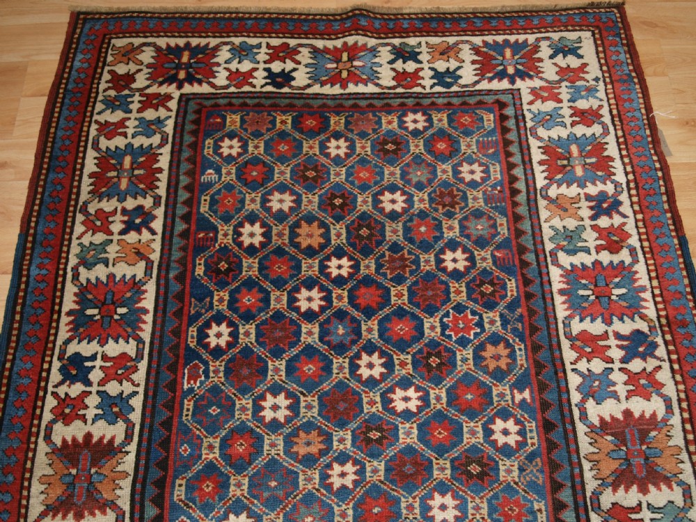 ANTIQUE CAUCASIAN GENDJE KAZAK RUG, LATTICE AND STAR DESIGN, CIRCA 1880. View IV