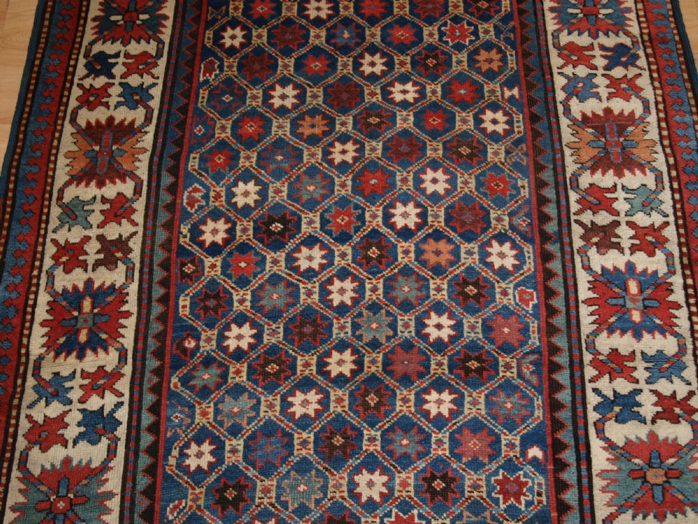 ANTIQUE CAUCASIAN GENDJE KAZAK RUG, LATTICE AND STAR DESIGN, CIRCA 1880. View V