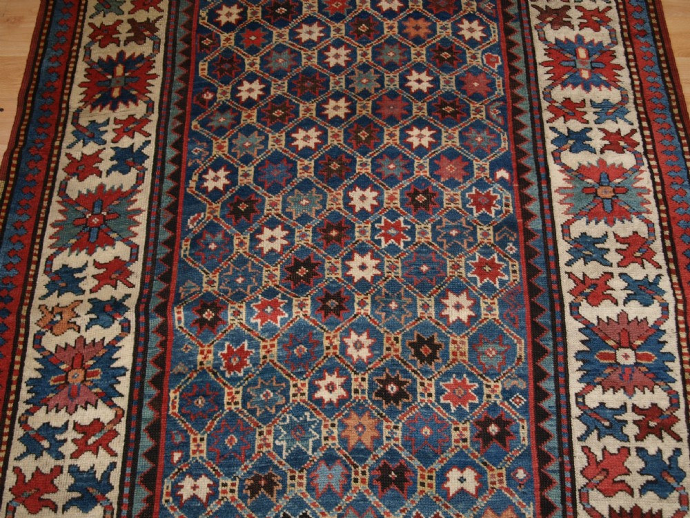 ANTIQUE CAUCASIAN GENDJE KAZAK RUG, LATTICE AND STAR DESIGN, CIRCA 1880. View VI