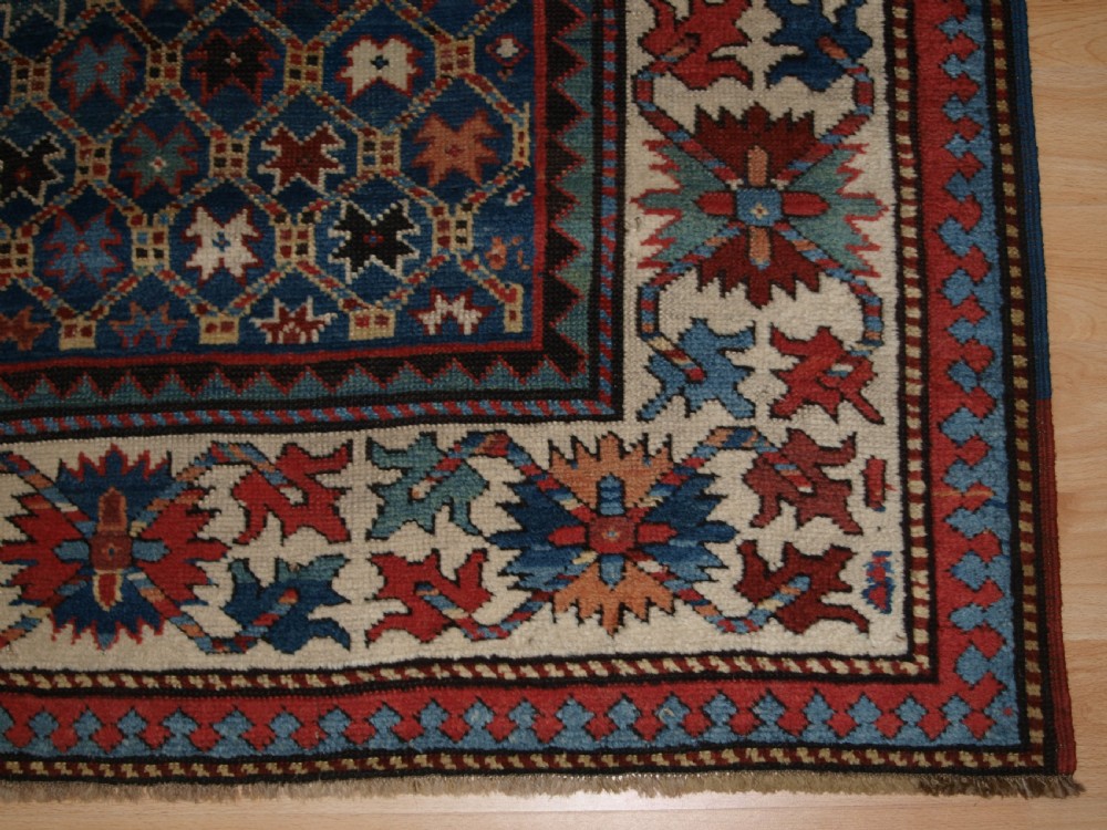 ANTIQUE CAUCASIAN GENDJE KAZAK RUG, LATTICE AND STAR DESIGN, CIRCA 1880. View VIII