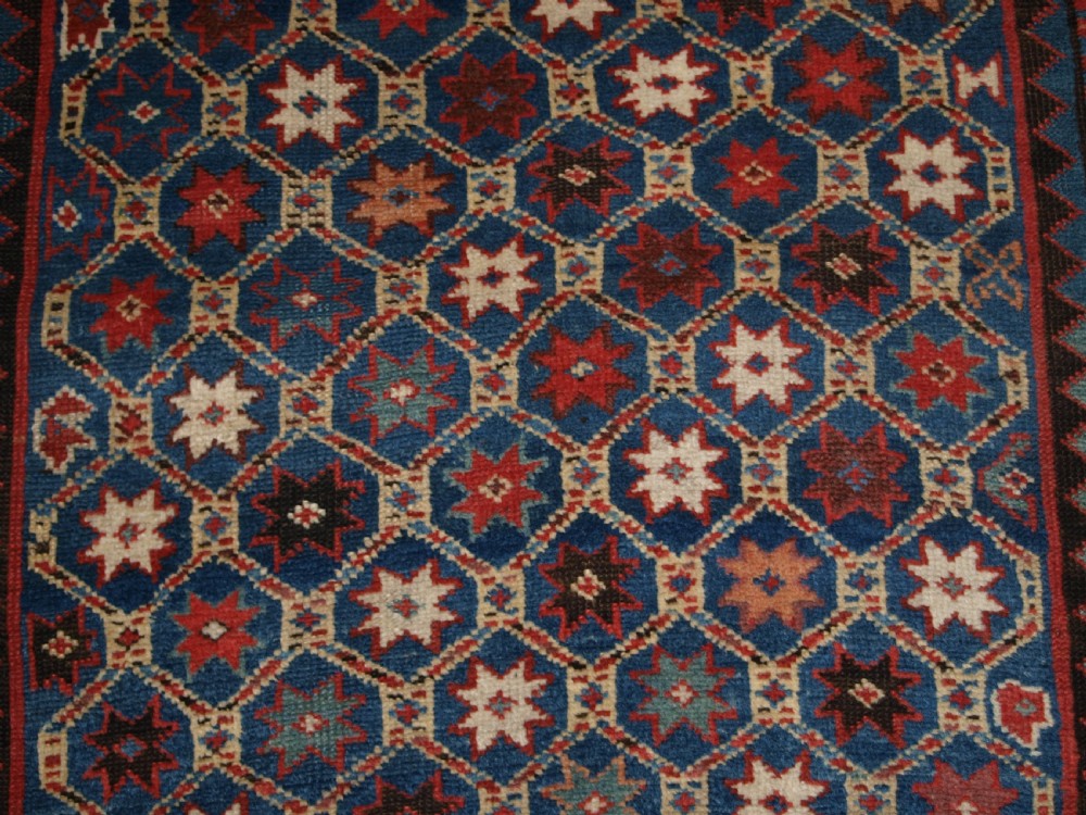 ANTIQUE CAUCASIAN GENDJE KAZAK RUG, LATTICE AND STAR DESIGN, CIRCA 1880. View X
