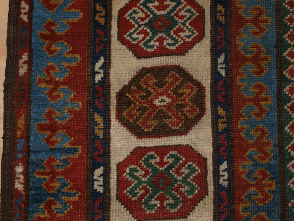 ANTIQUE CAUCASIAN KAZAK RUG OF COMPARTMENT DESIGN, BORDJALOU AREA, CIRCA 1890. View IV