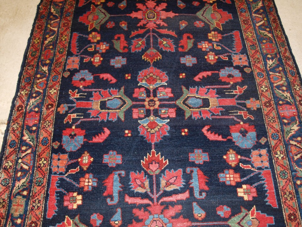 An antique Persian Hamadan wool runner featuring geometric floral patterns in red, green, and blue on a dark navy field surrounded by ornate multi-band borders. View VII