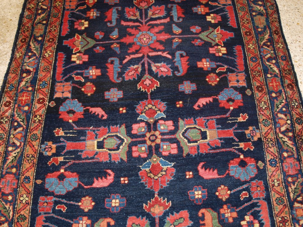 An antique Persian Hamadan wool runner featuring geometric floral patterns in red, green, and blue on a dark navy field surrounded by ornate multi-band borders. View VIII