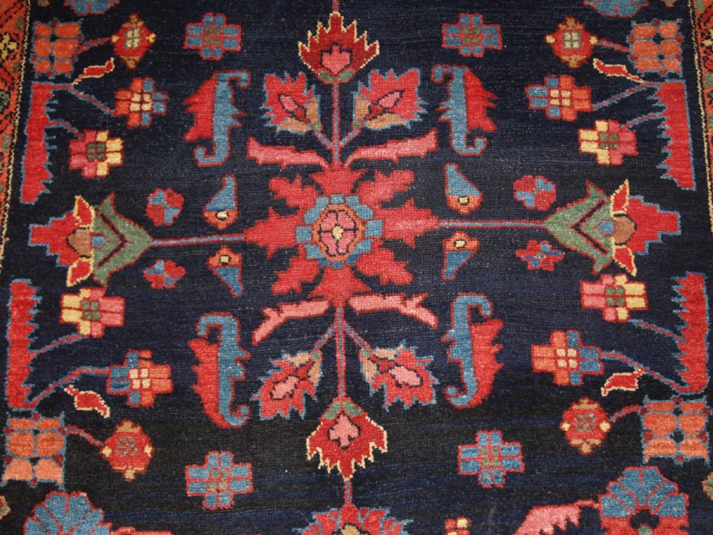 An antique Persian Hamadan wool runner featuring geometric floral patterns in red, green, and blue on a dark navy field surrounded by ornate multi-band borders. View XI