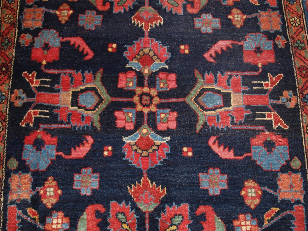 An antique Persian Hamadan wool runner featuring geometric floral patterns in red, green, and blue on a dark navy field surrounded by ornate multi-band borders. View XII
