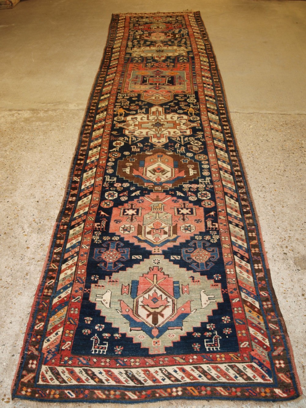 ANTIQUE SOUTH EAST CAUCASIAN RUNNER, SOFT COLOURS, PEOPLE AND ANIMALS, CIRCA 1900.