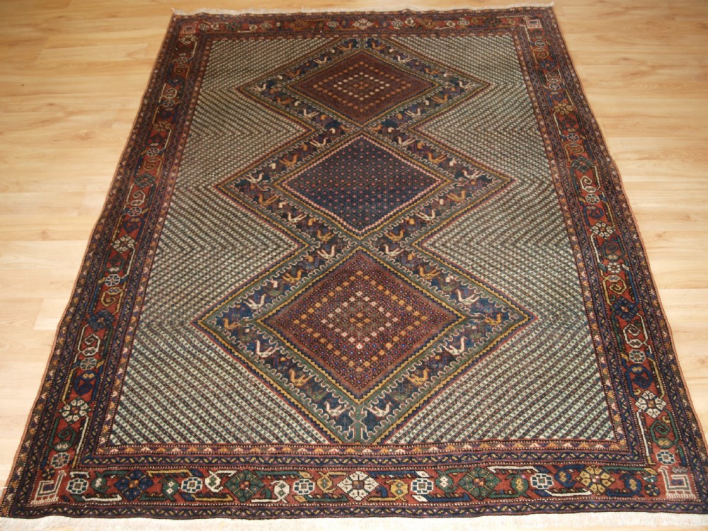 OLD KHAMSEH RUG, TRIPLE MEDALLION WITH BIRDS, CIRCA 1920.