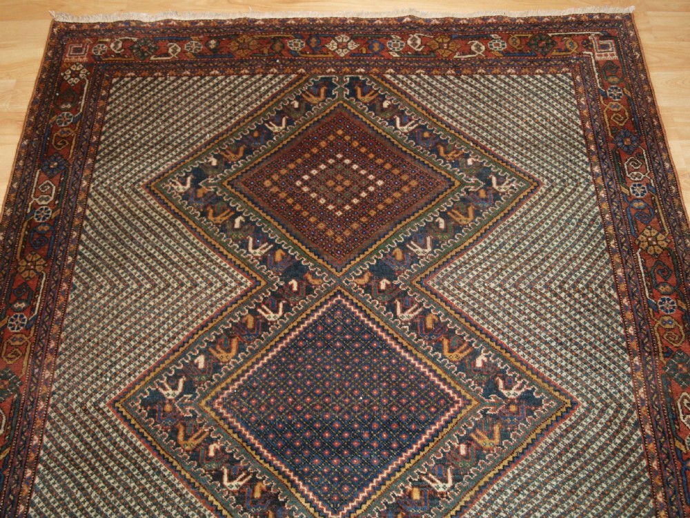 OLD KHAMSEH RUG, TRIPLE MEDALLION WITH BIRDS, CIRCA 1920. View IV