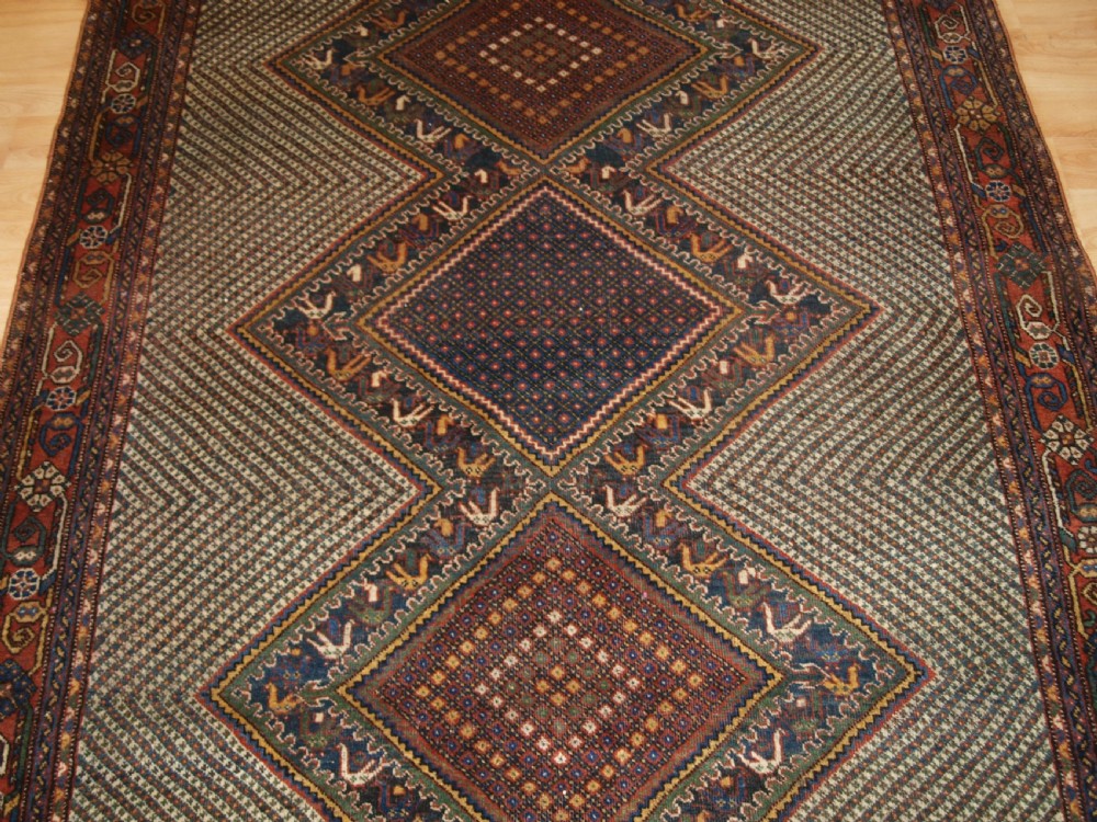 OLD KHAMSEH RUG, TRIPLE MEDALLION WITH BIRDS, CIRCA 1920. View V