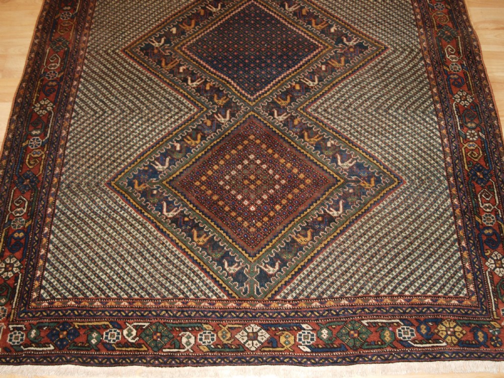 OLD KHAMSEH RUG, TRIPLE MEDALLION WITH BIRDS, CIRCA 1920. View VI