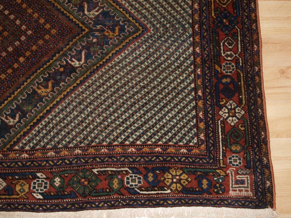 OLD KHAMSEH RUG, TRIPLE MEDALLION WITH BIRDS, CIRCA 1920. View IX