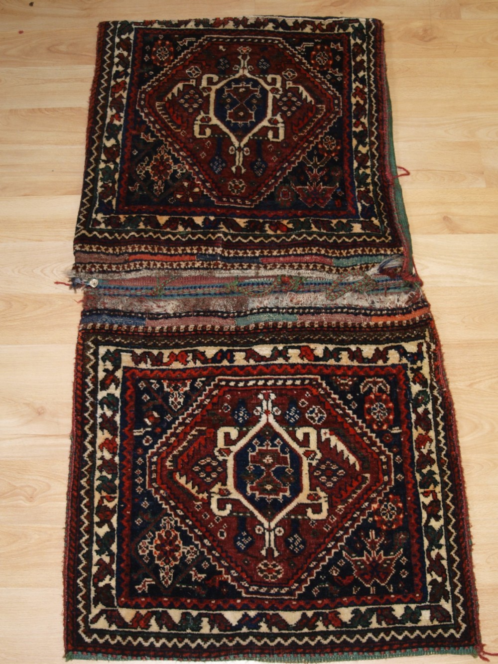 ANTIQUE COMPLETE QASHQAI KHORJIN SADDLE BAGS WITH PLAIN WEAVE BACK, CIRCA 1900/20.