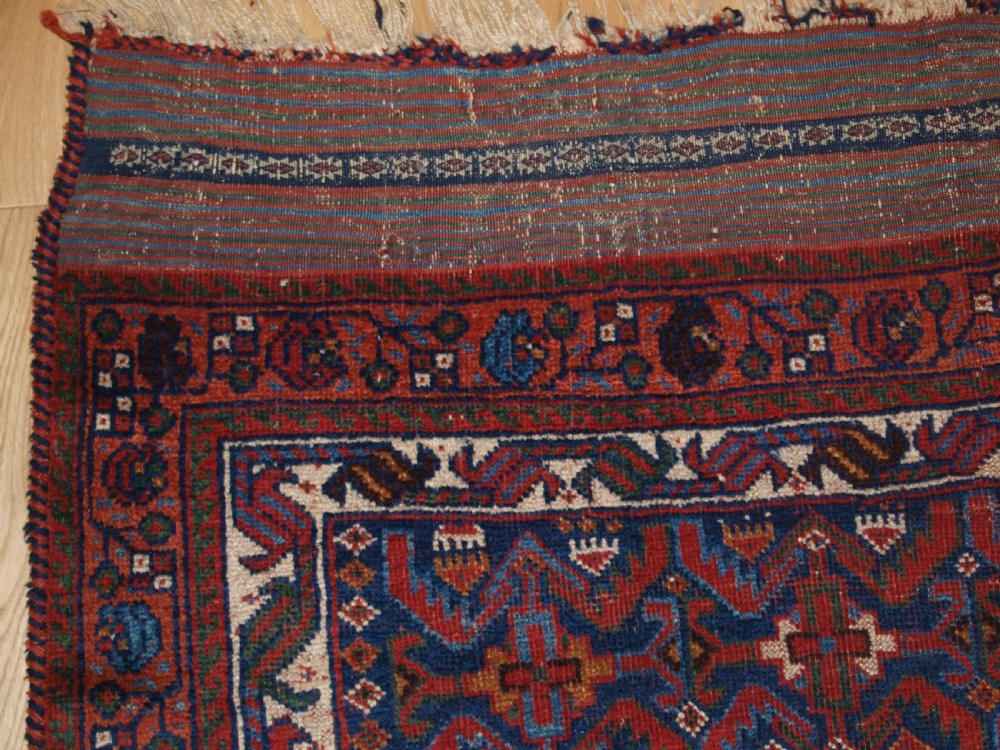 An antique hand-knotted Afshar rug featuring a repeating geometric Herati pattern in deep red, navy blue, and cream with a multi-band decorative border. View II