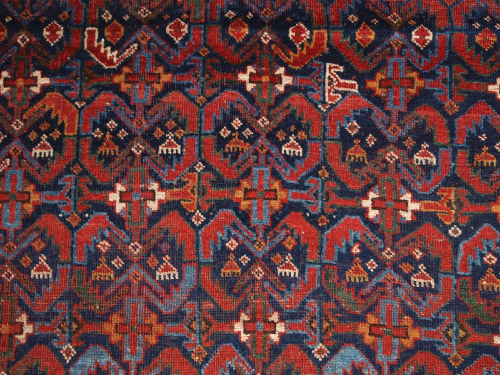 An antique hand-knotted Afshar rug featuring a repeating geometric Herati pattern in deep red, navy blue, and cream with a multi-band decorative border. View VIII