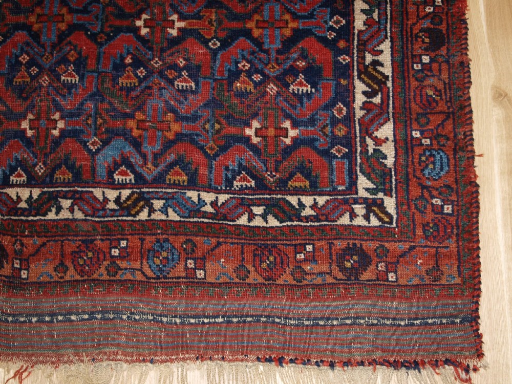 An antique hand-knotted Afshar rug featuring a repeating geometric Herati pattern in deep red, navy blue, and cream with a multi-band decorative border. View IX