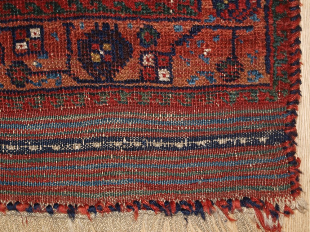 An antique hand-knotted Afshar rug featuring a repeating geometric Herati pattern in deep red, navy blue, and cream with a multi-band decorative border. View XI
