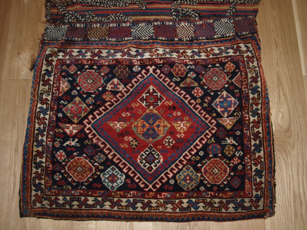 ANTIQUE COMPLETE QASHQAI KHORJIN SADDLE BAGS OF LARGE SIZE WITH PLAIN WEAVE BACK, CIRCA 1900. View II