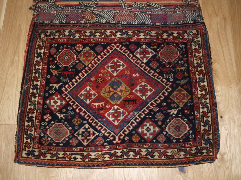 ANTIQUE COMPLETE QASHQAI KHORJIN SADDLE BAGS OF LARGE SIZE WITH PLAIN WEAVE BACK, CIRCA 1900. View III