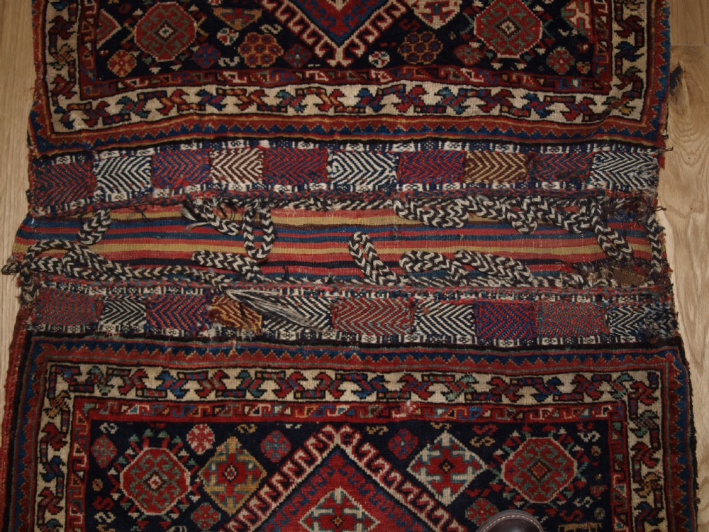 ANTIQUE COMPLETE QASHQAI KHORJIN SADDLE BAGS OF LARGE SIZE WITH PLAIN WEAVE BACK, CIRCA 1900. View IV