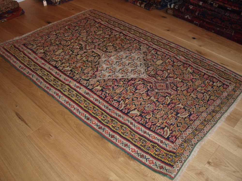 ANTIQUE SENNEH KILIM WITH MEDALLION DESIGN, SOFT COLOURS, CIRCA 1900. View II